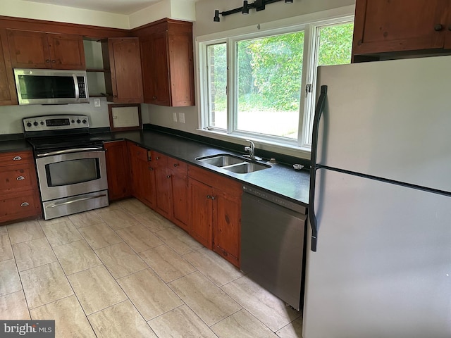 769 S Water St, Woodstock, VA 22664 - kitchen featuring stainless steel appliances, dark countertops, and brown cabinetry