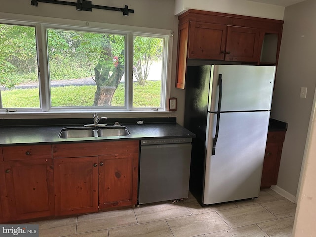 769 S Water St, Woodstock, VA 22664 - kitchen with freestanding refrigerator, dishwasher, dark countertops, and brown cabinetry