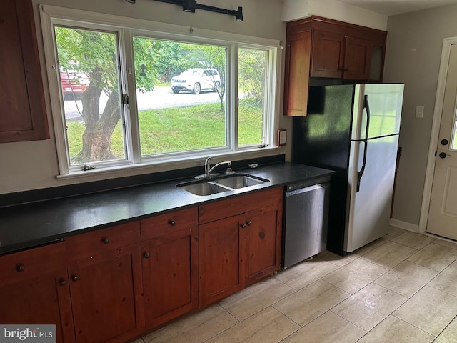 769 S Water St, Woodstock, VA 22664 - kitchen with appliances with stainless steel finishes, dark countertops, and brown cabinets