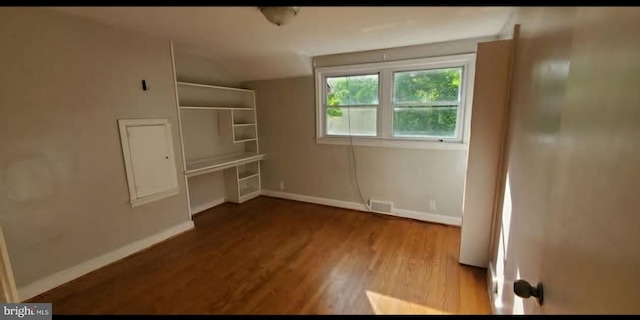 769 S Water St, Woodstock, VA 22664 - unfurnished bedroom with wood finished floors and electric panel