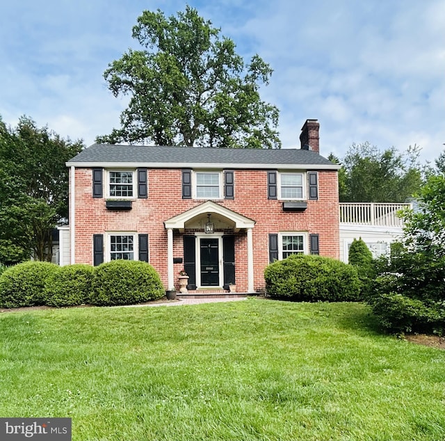 4 Haslet Way, Wilmington, DE 19807 - view of front of home featuring a chimney, a front lawn, and brick siding
