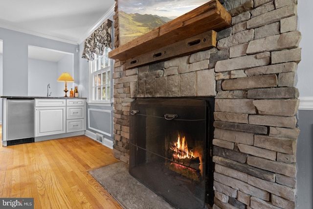 4 Haslet Way, Wilmington, DE 19807 - detailed view of ornamental molding, a stone fireplace, wood finished floors, and wet bar