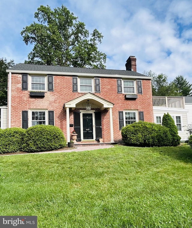 4 Haslet Way, Wilmington, DE 19807 - colonial home featuring a chimney, a front lawn, and brick siding