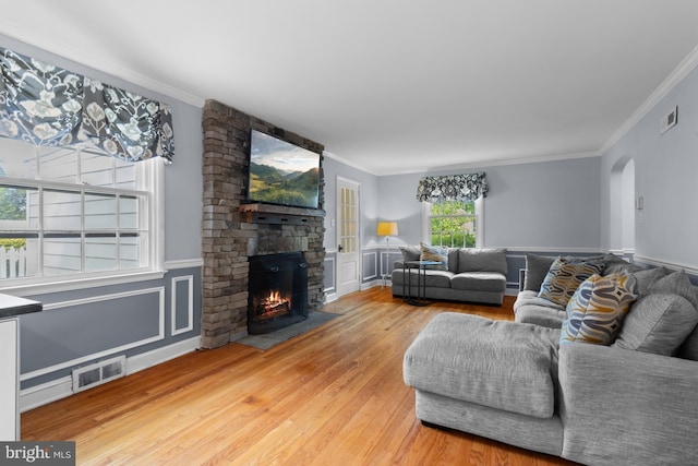 4 Haslet Way, Wilmington, DE 19807 - living area with a fireplace, wood finished floors, ornamental molding, arched walkways, and wainscoting