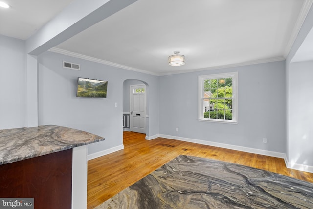 4 Haslet Way, Wilmington, DE 19807 - unfurnished living room featuring hardwood / wood-style floors, crown molding, plenty of natural light, and arched walkways
