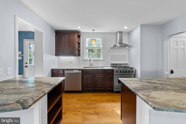 4 Haslet Way, Wilmington, DE 19807 - kitchen with stainless steel appliances, wall chimney exhaust hood, open shelves, light wood-type flooring, and backsplash