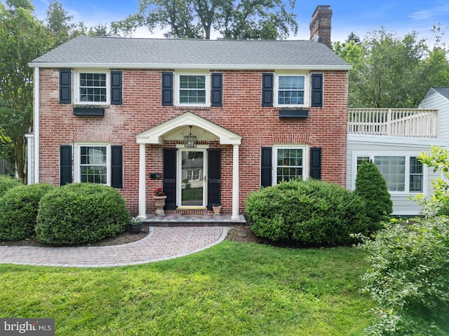 4 Haslet Way, Wilmington, DE 19807 - colonial house featuring a chimney, a front yard, brick siding, and roof with shingles
