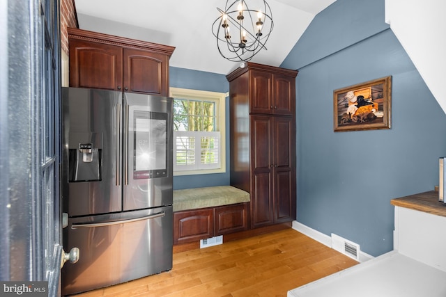 4 Haslet Way, Wilmington, DE 19807 - kitchen featuring stainless steel fridge, light wood-type flooring, vaulted ceiling, a chandelier, and decorative light fixtures