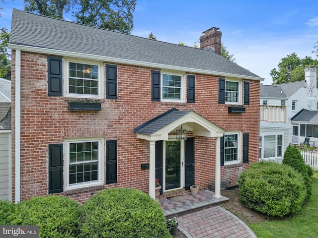 4 Haslet Way, Wilmington, DE 19807 - view of front facade featuring brick siding, a chimney, and roof with shingles