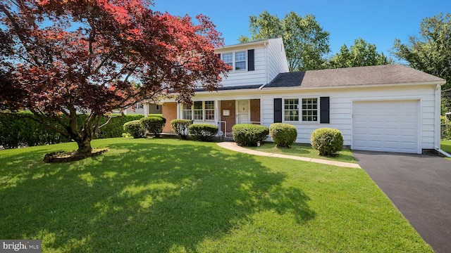 237 Louise Dr, Morrisville, PA 19067 - view of front of home featuring an attached garage, driveway, a front lawn, covered porch, and brick siding