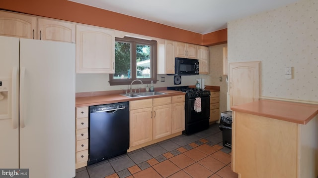 237 Louise Dr, Morrisville, PA 19067 - kitchen with black appliances, light brown cabinets, light tile patterned floors, light countertops, and wallpapered walls
