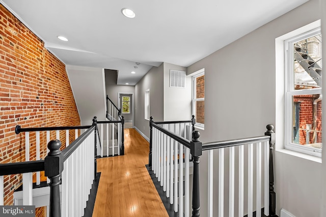 1717 Bank St, Baltimore, MD 21231 - corridor featuring an upstairs landing, wood finished floors, brick wall, and recessed lighting