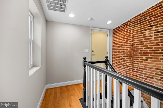 1717 Bank St, Baltimore, MD 21231 - hallway featuring recessed lighting, wood finished floors, and brick wall