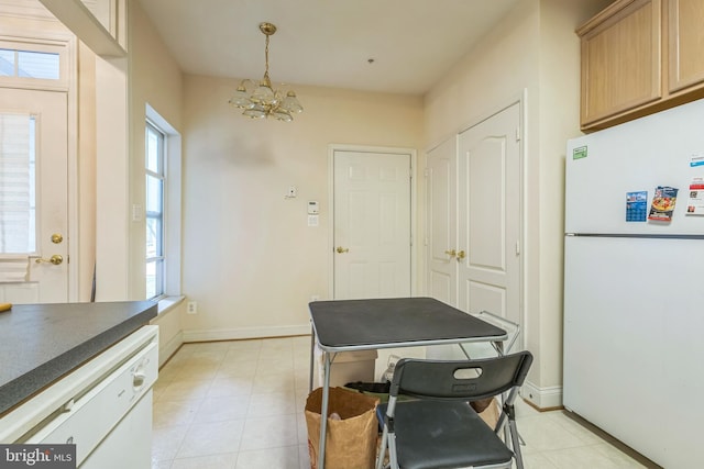 7206 Paperbark Ter, Laurel, MD 20707 - kitchen featuring freestanding refrigerator, a chandelier, plenty of natural light, and dark countertops