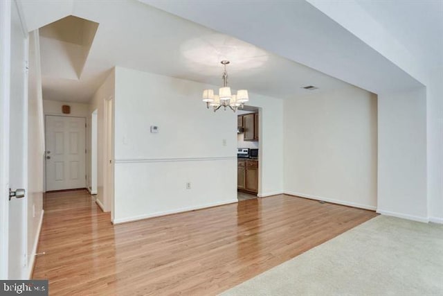 15246 Streamside Ct, Dumfries, VA 22025 - spare room featuring a chandelier and light wood-style floors