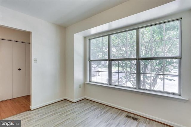 15246 Streamside Ct, Dumfries, VA 22025 - unfurnished bedroom featuring wood finished floors and multiple windows