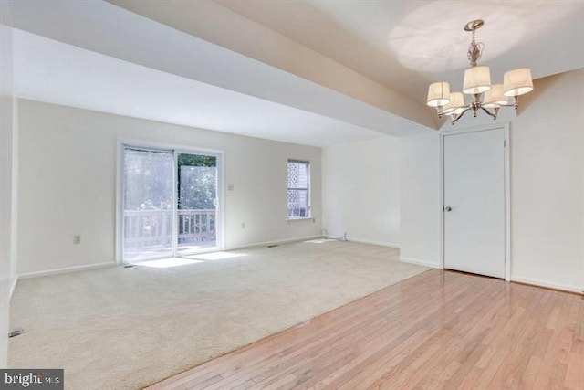 15246 Streamside Ct, Dumfries, VA 22025 - empty room featuring a chandelier, wood finished floors, and carpet