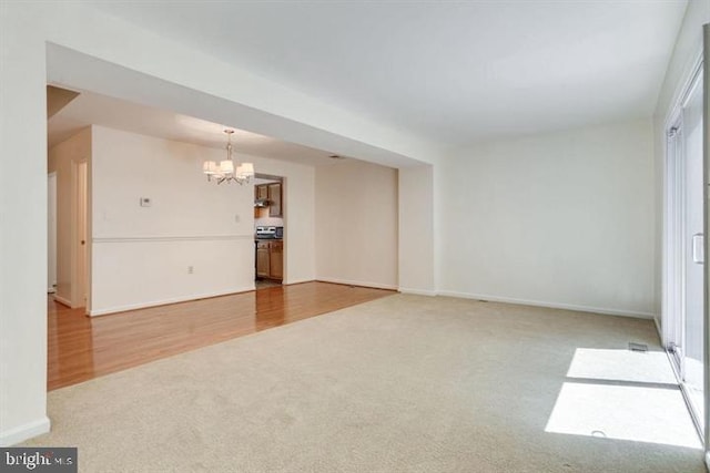 15246 Streamside Ct, Dumfries, VA 22025 - empty room featuring a chandelier and carpet floors