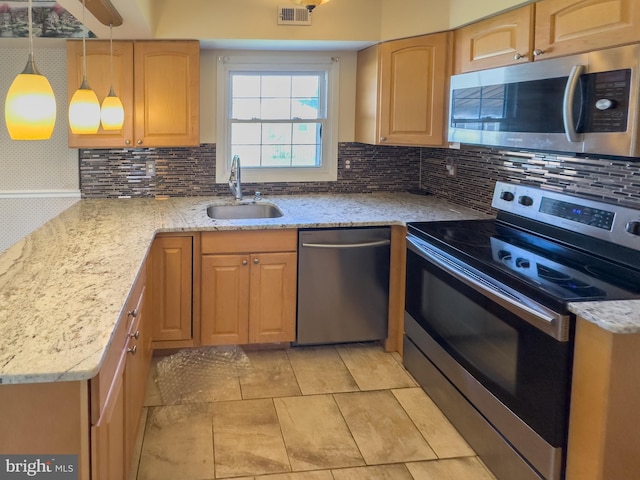 35 Gentry Ln, Willingboro, NJ 08046 - kitchen with stainless steel appliances, decorative backsplash, light stone counters, decorative light fixtures, and light brown cabinetry