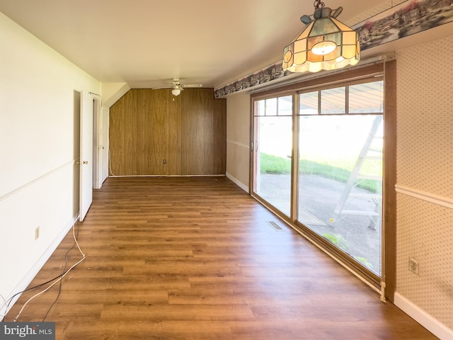 35 Gentry Ln, Willingboro, NJ 08046 - unfurnished dining area with wallpapered walls, an accent wall, wood finished floors, ceiling fan, and wooden walls