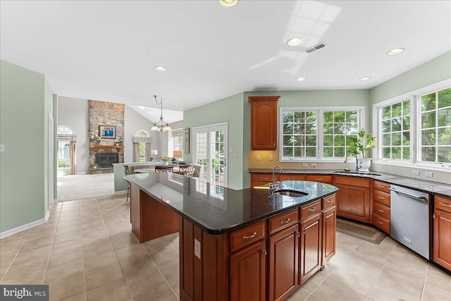 4 William Howard Dr, Glen Mills, PA 19342 - kitchen with dishwasher, a kitchen island with sink, a stone fireplace, open floor plan, and dark stone counters