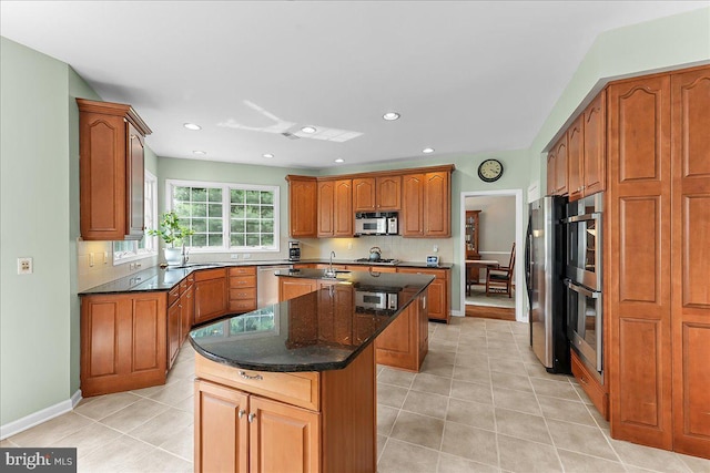 4 William Howard Dr, Glen Mills, PA 19342 - kitchen with a kitchen island, stainless steel appliances, light tile patterned floors, brown cabinets, and recessed lighting