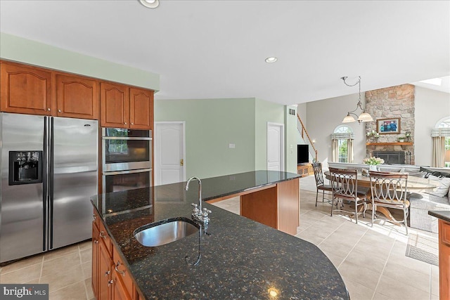 4 William Howard Dr, Glen Mills, PA 19342 - kitchen with appliances with stainless steel finishes, light tile patterned floors, brown cabinets, and dark stone countertops