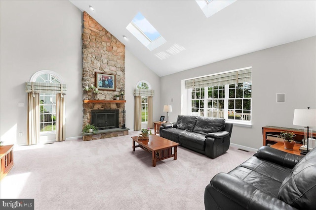 4 William Howard Dr, Glen Mills, PA 19342 - living room featuring a skylight, high vaulted ceiling, plenty of natural light, a stone fireplace, and carpet floors