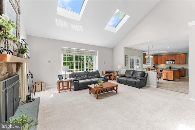 4 William Howard Dr, Glen Mills, PA 19342 - living room featuring a skylight, high vaulted ceiling, light colored carpet, and a fireplace with raised hearth