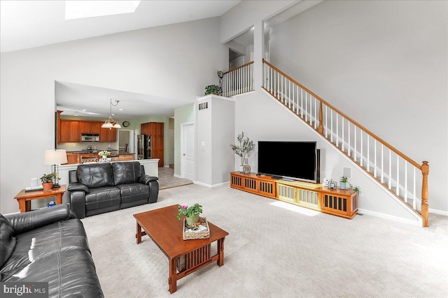 4 William Howard Dr, Glen Mills, PA 19342 - living area with high vaulted ceiling, stairway, light colored carpet, and a skylight