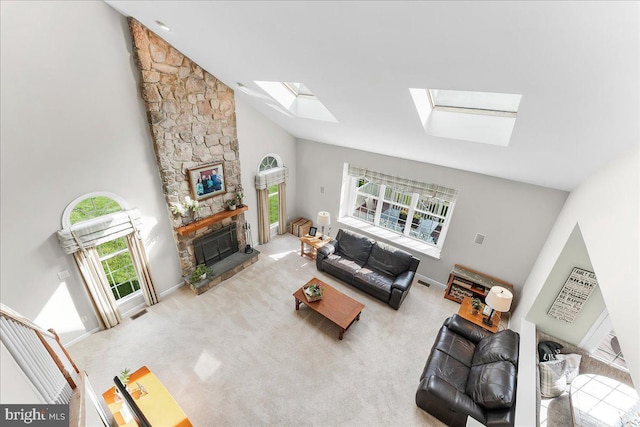 4 William Howard Dr, Glen Mills, PA 19342 - living area with a skylight, high vaulted ceiling, a stone fireplace, and carpet floors