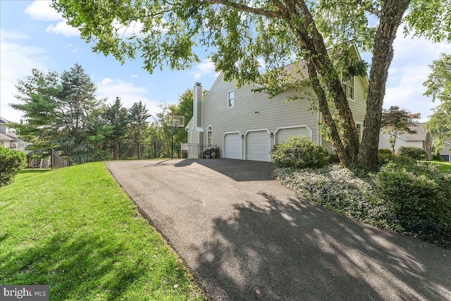 4 William Howard Dr, Glen Mills, PA 19342 - view of property exterior featuring asphalt driveway, an attached garage, and a chimney