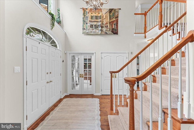 4 William Howard Dr, Glen Mills, PA 19342 - foyer with wood finished floors, stairs, a towering ceiling, a chandelier, and french doors