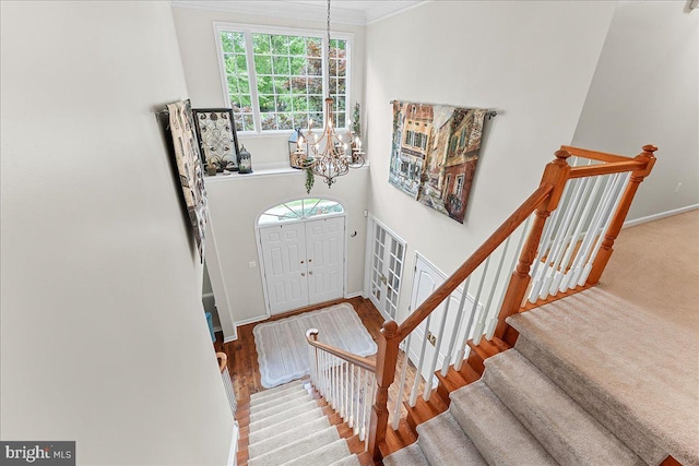 4 William Howard Dr, Glen Mills, PA 19342 - foyer featuring a chandelier, stairway, ornamental molding, and wood finished floors