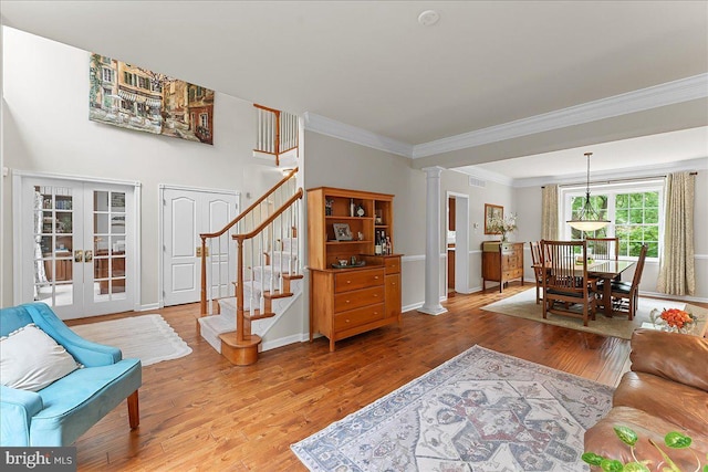 4 William Howard Dr, Glen Mills, PA 19342 - living room with ornate columns, crown molding, french doors, light wood-style floors, and stairs