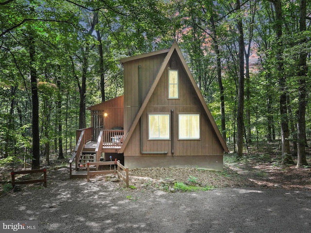 13 Mountainside Dr, Berkeley Springs, WV 25411 - view of front of property featuring a wooden deck, a forest view, and stairs