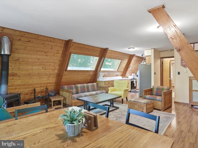 13 Mountainside Dr, Berkeley Springs, WV 25411 - living room featuring light wood-style flooring, wood walls, and a wood stove