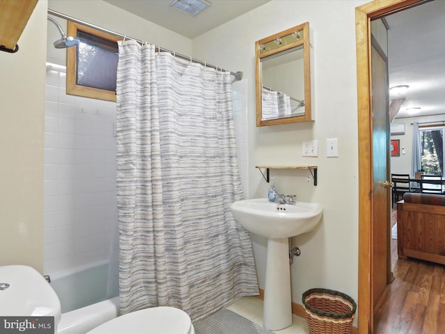 13 Mountainside Dr, Berkeley Springs, WV 25411 - full bath featuring wood finished floors and shower / bath combo with shower curtain