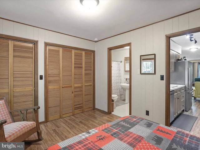 13 Mountainside Dr, Berkeley Springs, WV 25411 - bedroom featuring two closets, wood finished floors, ensuite bathroom, and ornamental molding
