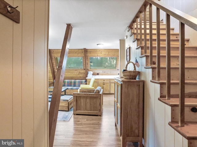 13 Mountainside Dr, Berkeley Springs, WV 25411 - bar area with light wood-style flooring, stairs, and wood walls