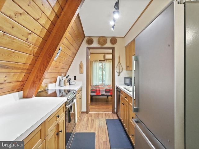 13 Mountainside Dr, Berkeley Springs, WV 25411 - kitchen featuring stainless steel appliances, light wood-type flooring, light countertops, and a wall unit AC