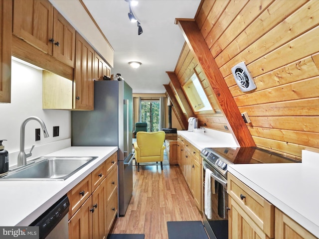 13 Mountainside Dr, Berkeley Springs, WV 25411 - kitchen with appliances with stainless steel finishes, light countertops, light wood-style floors, and wood walls