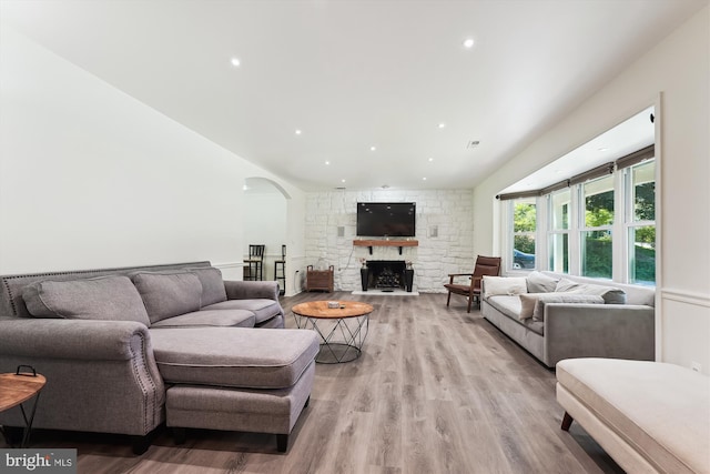 12116 Long Ridge Ln, Bowie, MD 20715 - living room featuring arched walkways, light wood finished floors, a fireplace, and recessed lighting