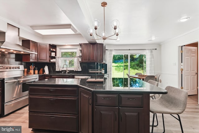 12116 Long Ridge Ln, Bowie, MD 20715 - kitchen featuring range with two ovens, wall chimney exhaust hood, crown molding, a kitchen breakfast bar, and plenty of natural light