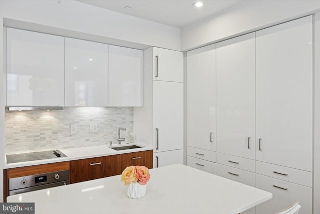 621 S 24th St Unit 204, Philadelphia, PA 19146 - kitchen with oven, modern cabinets, black electric cooktop, and white cabinets