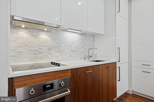 621 S 24th St Unit 204, Philadelphia, PA 19146 - kitchen featuring stainless steel oven, modern cabinets, extractor fan, and black electric stovetop