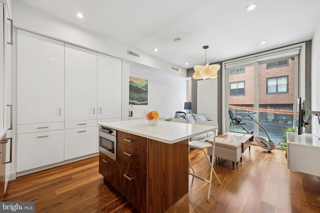 621 S 24th St Unit 204, Philadelphia, PA 19146 - kitchen featuring modern cabinets, stainless steel microwave, a kitchen island, white cabinets, and recessed lighting