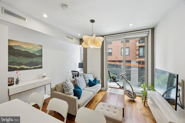 621 S 24th St Unit 204, Philadelphia, PA 19146 - living room with wood finished floors, recessed lighting, and a wall of windows