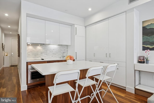 621 S 24th St Unit 204, Philadelphia, PA 19146 - kitchen with stainless steel oven, modern cabinets, dark wood-type flooring, light countertops, and recessed lighting