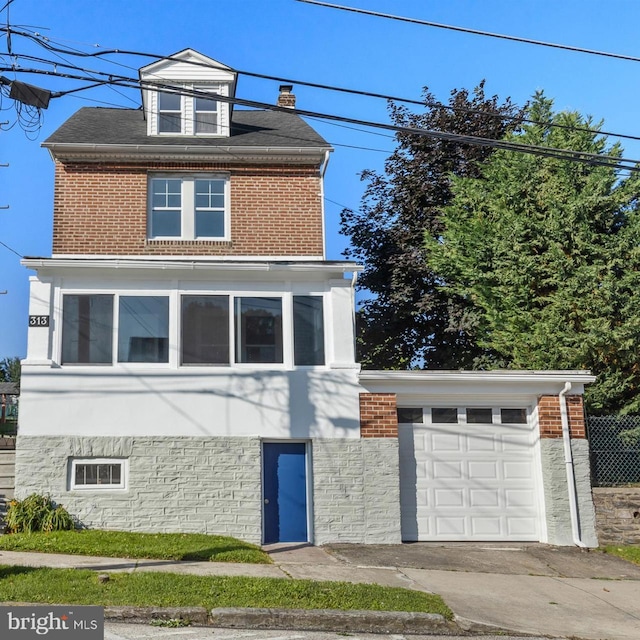 313 W 5th Ave, Conshohocken, PA 19428 - traditional style home featuring brick siding, driveway, and an attached garage